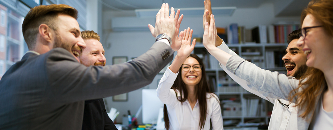 group of people high fiving at meeting_1280x500