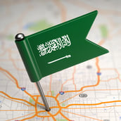 Small Flag of Saudi Arabia on a Map Background with Selective Focus_