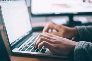 Person typing on laptop, guide to the IEC 62368-1 standard